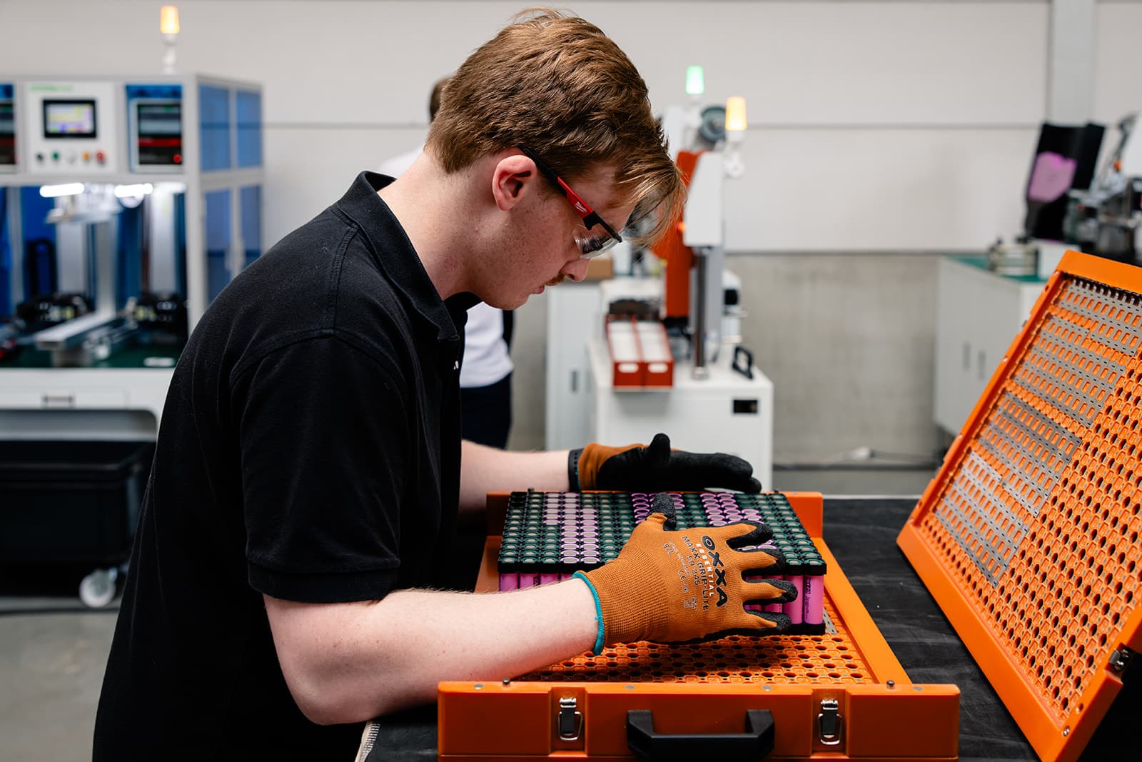 Ampacon employee placing battery pack. 