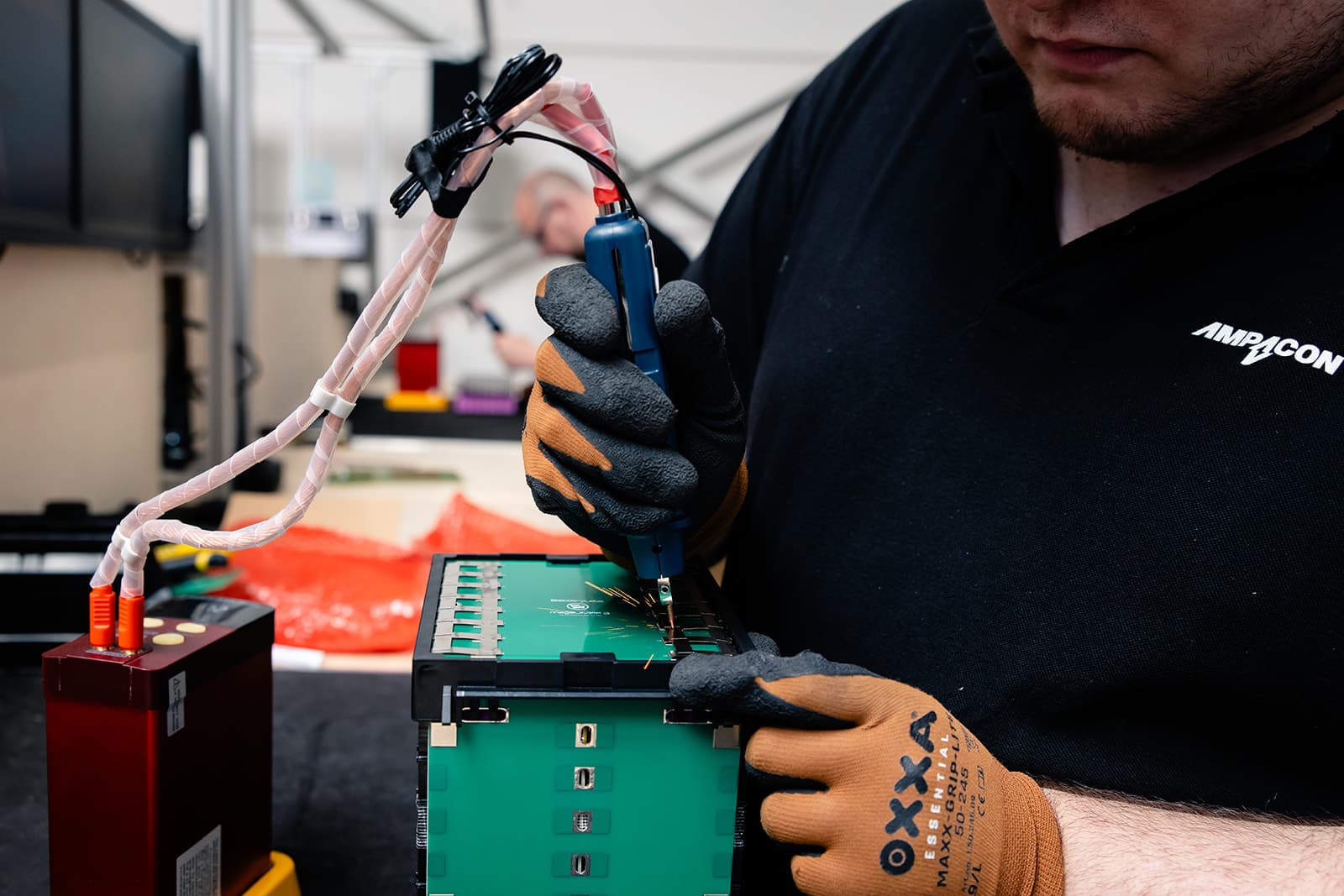 Ampacon employee soldering a battery
